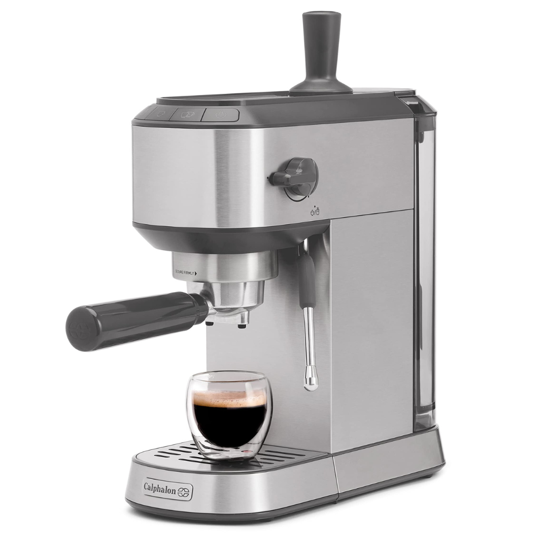 Espresso machine by Calphalon, featuring a portafilter handle, steam wand, and a removable water tank. A glass cup with espresso is placed on the drip tray.