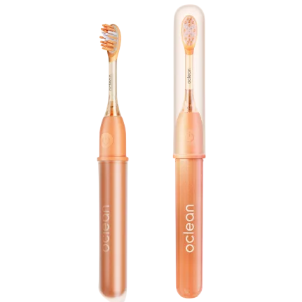 Two orange Oclean electric toothbrushes are shown, featuring cylindrical handles and protective cases.