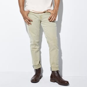 Light green chino pants paired with brown leather lace-up boots.