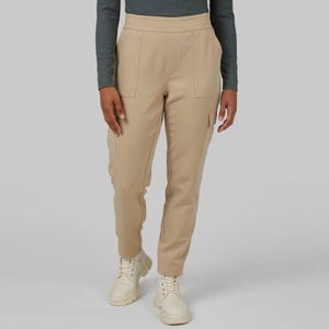 Beige cargo pants with a soft stretch fabric, featuring side pockets on the thighs, a fitted waistband, and cuffed ankles.
