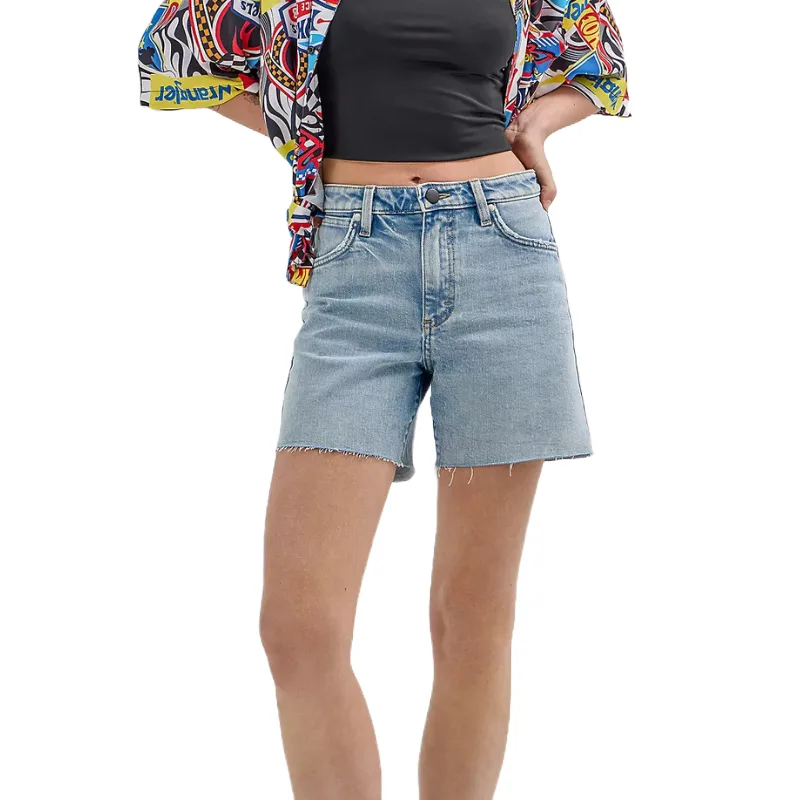 A person wears light blue, relaxed-fit denim shorts with a raw hem, paired with a black crop top and a colorful, patterned shirt.