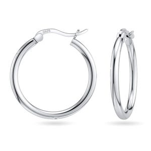 A pair of silver hoop earrings with a 925 stamp indicating sterling silver purity.