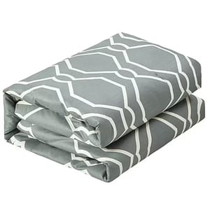 A folded gray bed sheet set featuring a white geometric pattern.