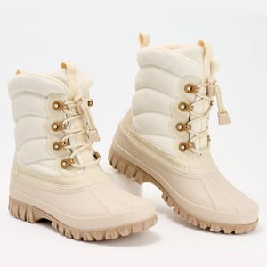 A pair of beige, lace-up winter boots with thick rubber soles.