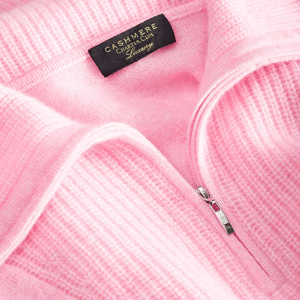 Pink cashmere sweater with a front zipper, featuring a label that reads \“Cashmere Charter Club Luxury.\“