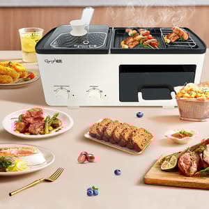 A multifunctional appliance featuring a deep fryer with a glass lid and a grill section for cooking. Surrounded by various foods, including meats, bread, and vegetables, highlighting its versatility.