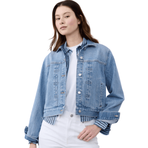 Model wearing a light blue denim jacket over a striped shirt and white pants.