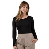 A person is wearing a black long-sleeve top and beige pants with an elastic waistband, posing with one hand in a pocket.