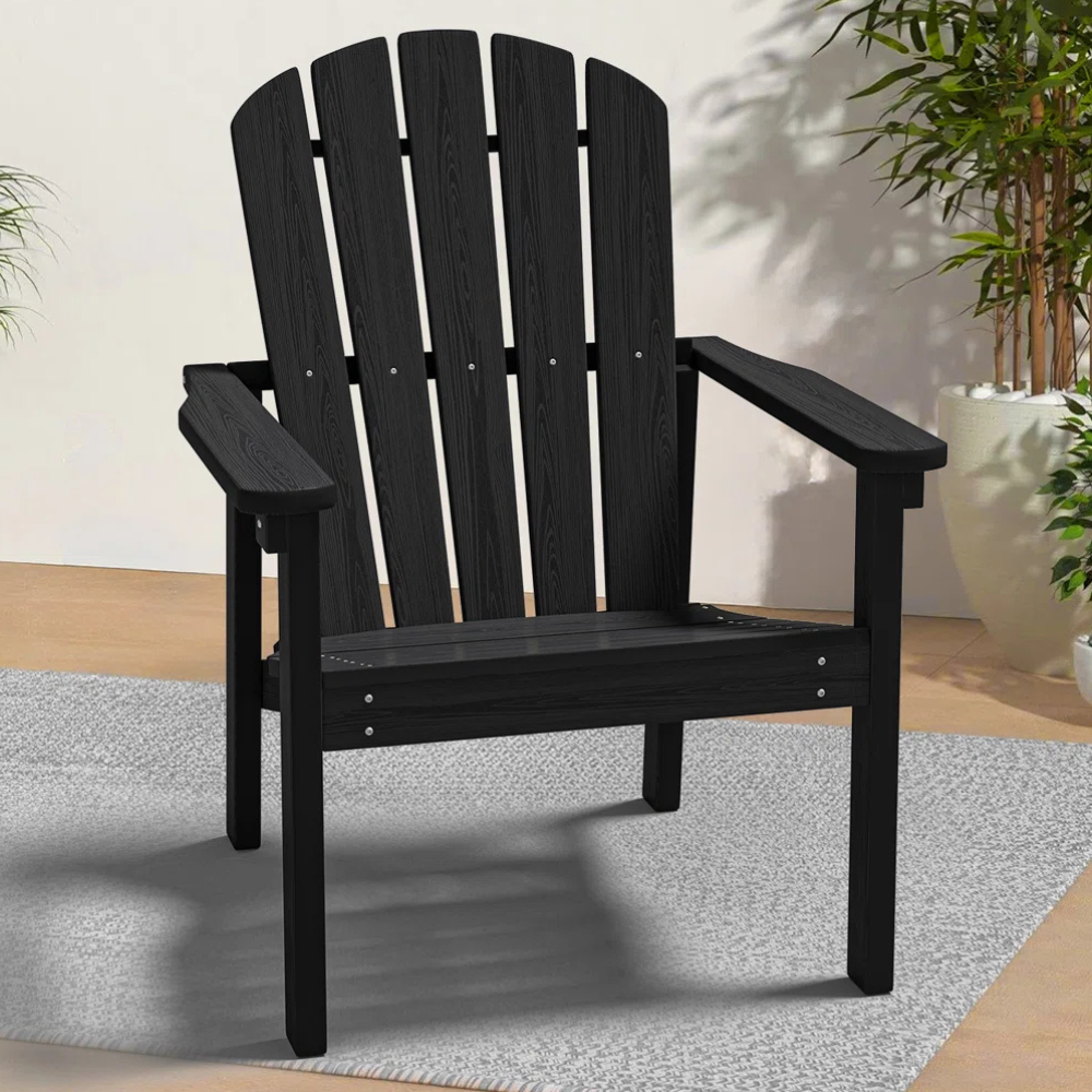 Black Adirondack chair with a slatted backrest, wide armrests, and set on a light gray rug.