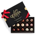 Box of Godiva chocolates: a black package adorned with a red ribbon and gold accents, featuring 15 assorted truffles in various coatings.