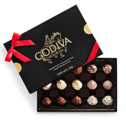 Box of Godiva chocolates: a black package adorned with a red ribbon and gold accents, featuring 15 assorted truffles in various coatings.
