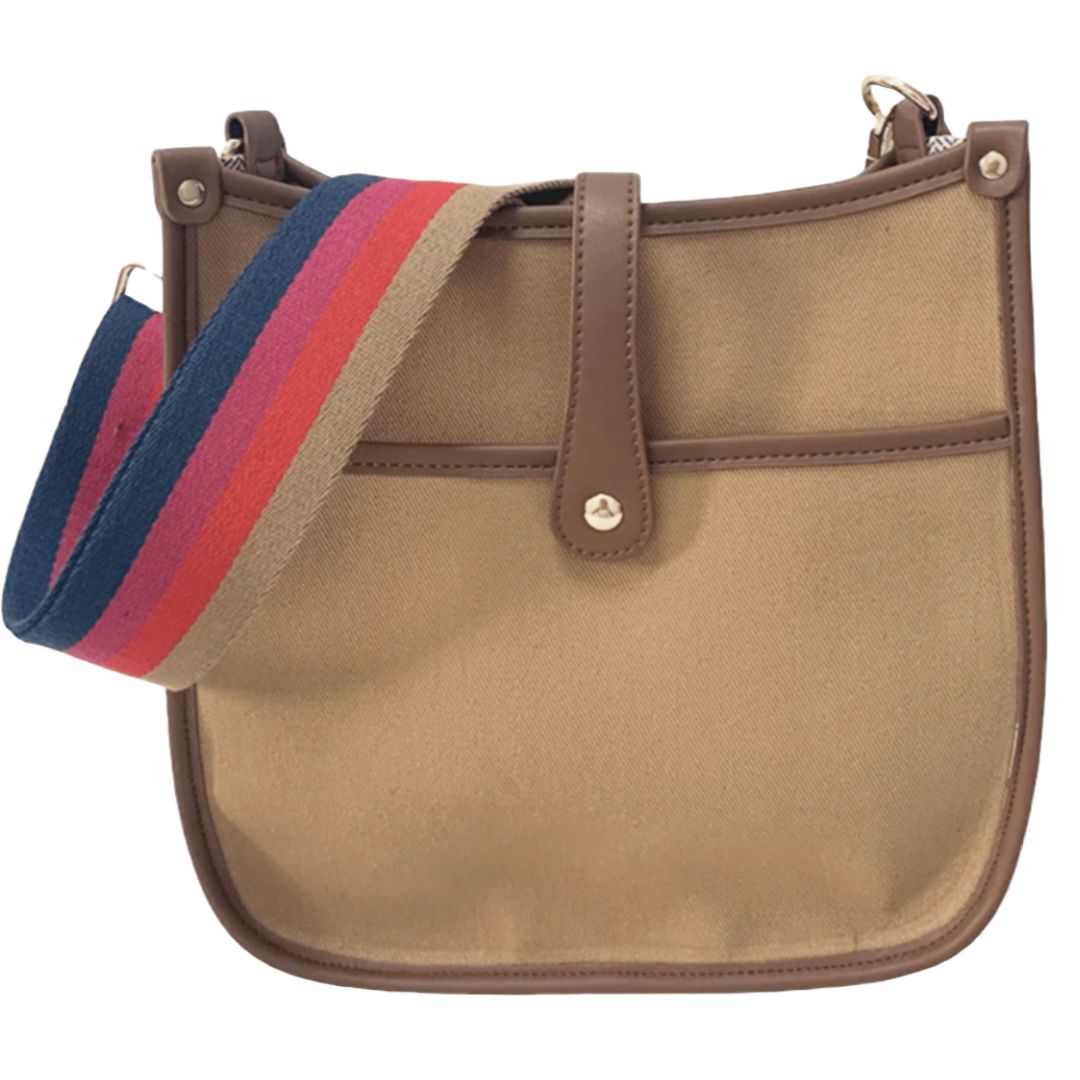 A tan canvas shoulder bag with brown leather accents and a multicolored striped strap.