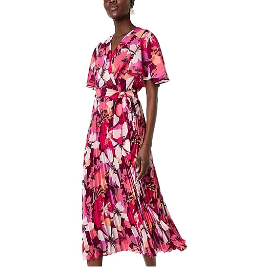 A vibrant floral print dress with a V-neckline, short sleeves, and a pleated skirt. The dress features a matching waist tie for a cinched appearance.
