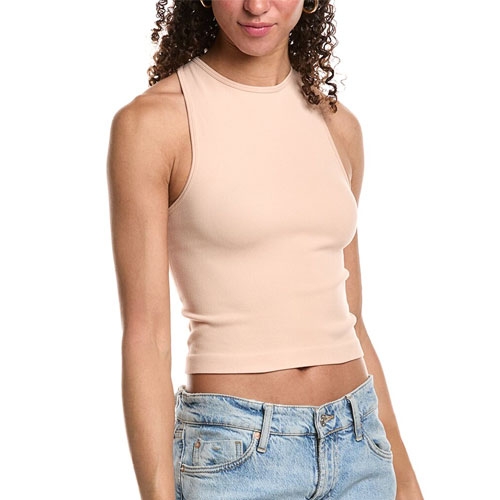 The Free People Hayley Brami is a sleeveless, high-neck cropped tank in a nude color, paired with light blue denim jeans.