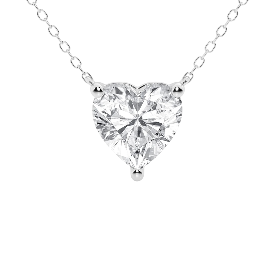 A heart-shaped diamond pendant on a delicate silver chain, featuring a three-prong setting.