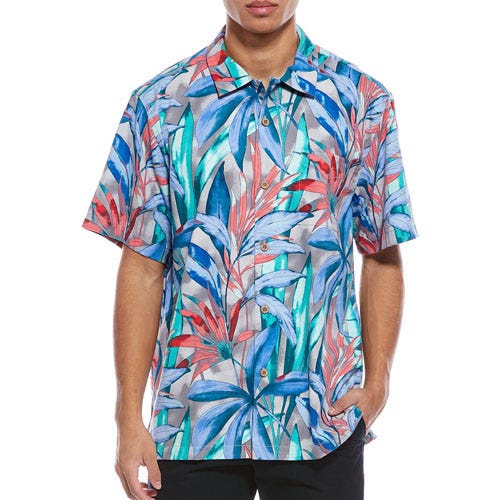 A short-sleeve button-up shirt featuring a vibrant tropical leaf pattern in blue, red, and teal tones.