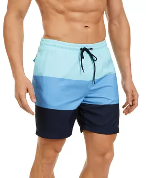 A man wearing blue gradient swim shorts with a drawstring waist.