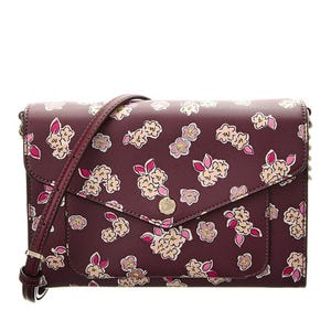 Burgundy crossbody bag with a flap closure, adorned with a pattern of flowers and rabbit cartoons, and an adjustable strap.