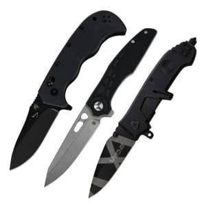 Three folding knives, each with distinct designs: a black-handled knife with a dark blade, a knife with a silver-toned blade featuring a cutout, and a black knife with a black blade featuring grey stripes.