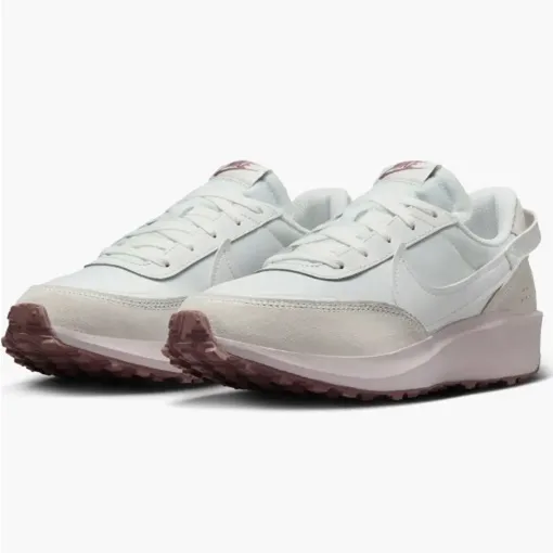 A pair of white sneakers with a pink-tinted sole.