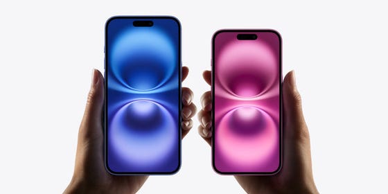 two hands are holding one Apple iPhone 16 Plus displaying a blue abstract graphic onscreen and an iPhone 16 with a pink abstract graphic onscreen