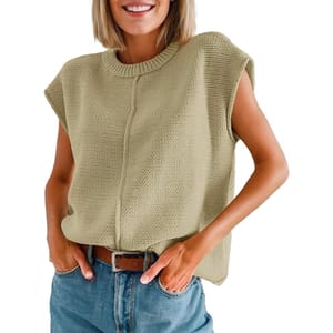 A light beige sleeveless sweater with a textured knit pattern, featuring a round neckline and a subtle central seam, paired with blue jeans and a brown belt.