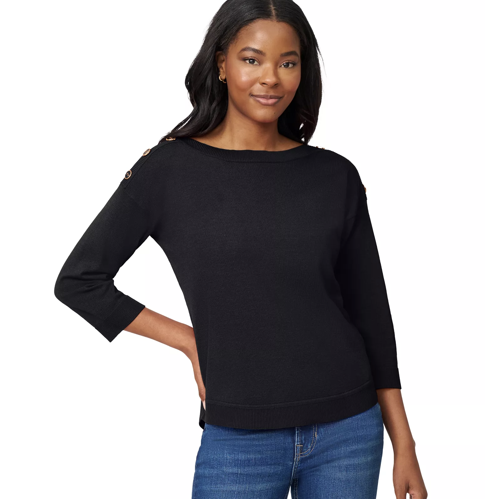 A woman wears a black sweater with button details on the shoulders and three-quarter sleeves, paired with blue jeans.