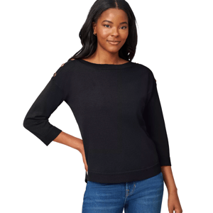A woman wears a black sweater with button details on the shoulders and three-quarter sleeves, paired with blue jeans.