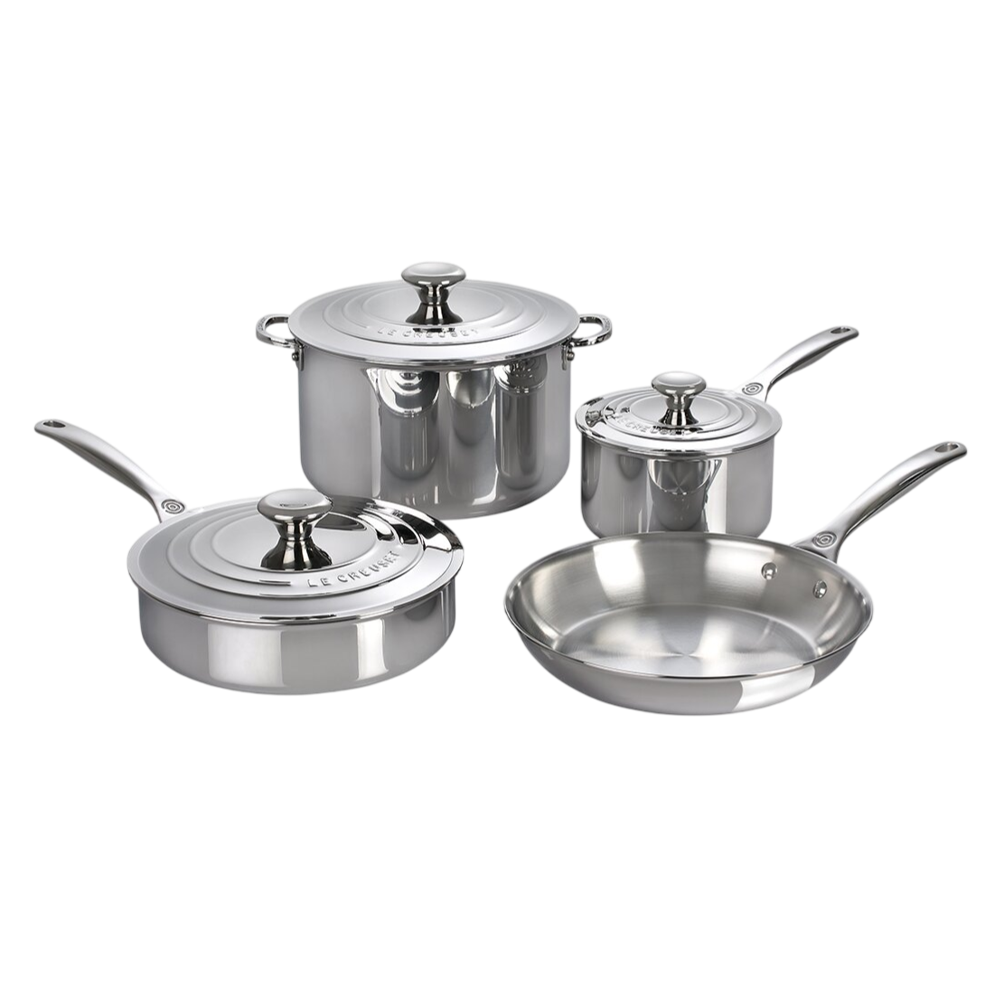 Stainless steel cookware set including a saucepan, stockpot, frying pan, and sauté pan, each with a matching lid, from Le Creuset.