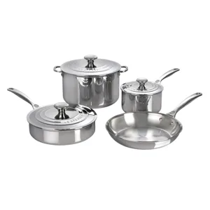 Stainless steel cookware set including a saucepan, stockpot, frying pan, and sauté pan, each with a matching lid, from Le Creuset.