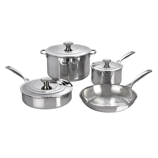 Stainless steel cookware set including a saucepan, stockpot, frying pan, and sauté pan, each with a matching lid, from Le Creuset.