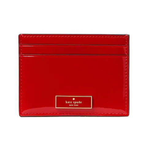 Red Kate Spade New York cardholder with a glossy finish and multiple card slots.