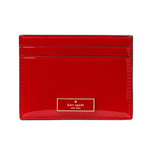 Red Kate Spade New York cardholder with a glossy finish and multiple card slots.