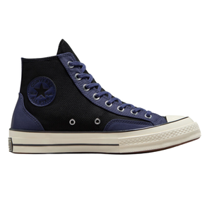 High-top Converse Chuck Taylor All Star sneaker with a black and navy canvas upper, white toe cap, and cream sole. Features include navy laces, metal eyelets, and the iconic Converse patch on the ankle.