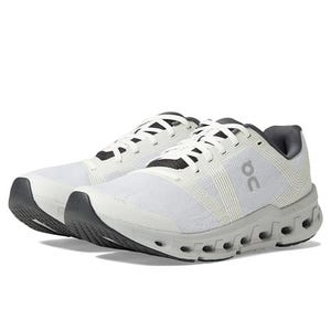 Pair of white athletic shoes with black accents and distinctive sole pattern.