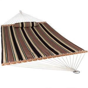Striped fabric hammock with a pillow, featuring spreader bars and white ropes.
