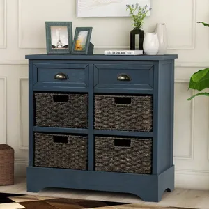A blue wooden cabinet with two drawers and four wicker baskets is topped with framed photos, books, and vases.