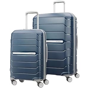 Two blue hard-shell suitcases with telescopic handles and four double wheels, designed for easy maneuverability and durability.