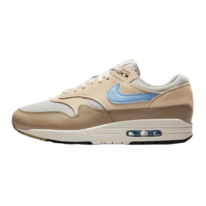 Nike Air Max 1 sneaker featuring a beige and light brown upper with a light blue swoosh, a white midsole, and visible Air unit.