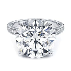 A 14k white gold ring featuring a 6-carat, round lab-grown diamond as the centerpiece, with smaller diamonds set along the band.