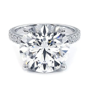 A 14k white gold ring featuring a 6-carat, round lab-grown diamond as the centerpiece, with smaller diamonds set along the band.