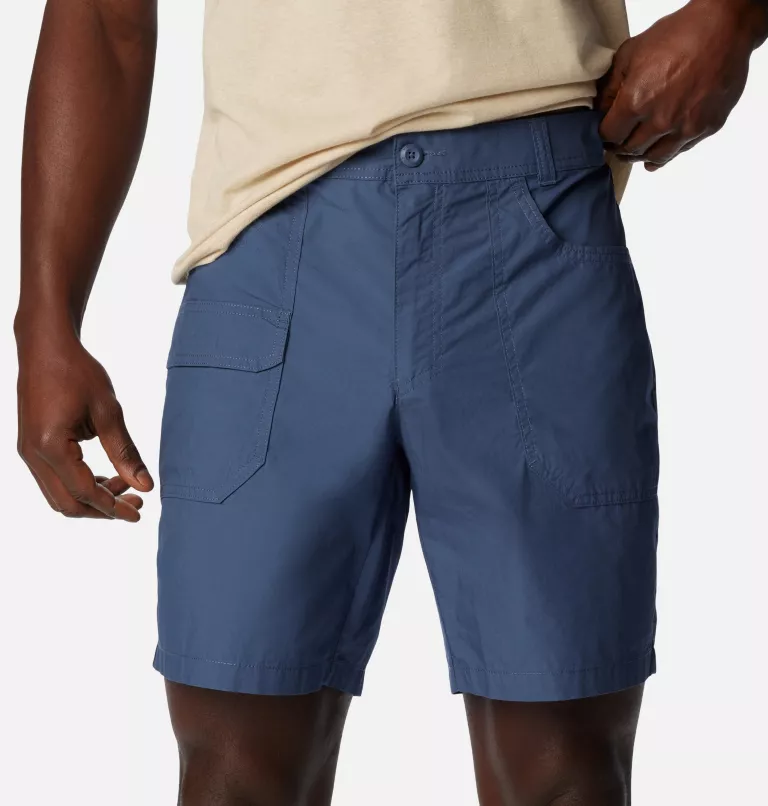 A person wearing blue cargo shorts with pockets and a light-colored shirt.