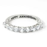 Sterling Silver & Topaz Eternity Band featuring a row of sparkling topaz gems set in a sleek silver band with \“HAPPY ANNIVERSARY\“ engraved on the inside.