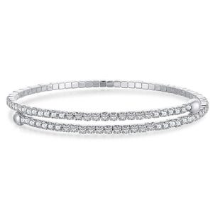A double-row silver bracelet featuring two parallel lines of clear gemstones. The bracelet has a flexible design with round bead accents at the ends.