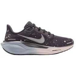 A dark-colored Nike running shoe with a speckled pattern, featuring a large swoosh logo, cushioned sole, and \“AIR ZOOM\“ branding on the side.