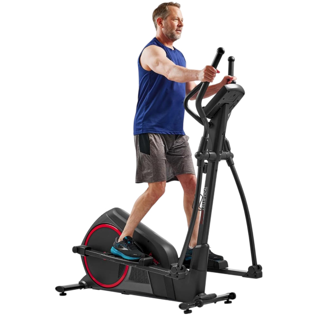 A man exercises on a black elliptical machine with a front flywheel, featuring red accents and dual-action handles, while wearing a blue sleeveless shirt and gray shorts.