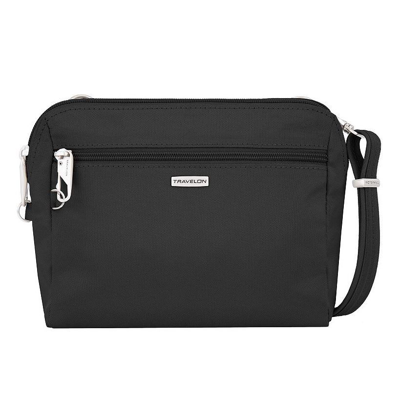 Black Travelon Anti-Theft Crossbody bag with a front zippered pocket, silver hardware, and an adjustable strap. The bag features a compact and sleek design ideal for secure daily use.