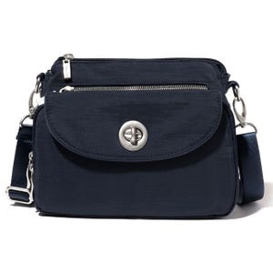 Navy blue shoulder bag with front flap, zipper compartment, and adjustable strap.
