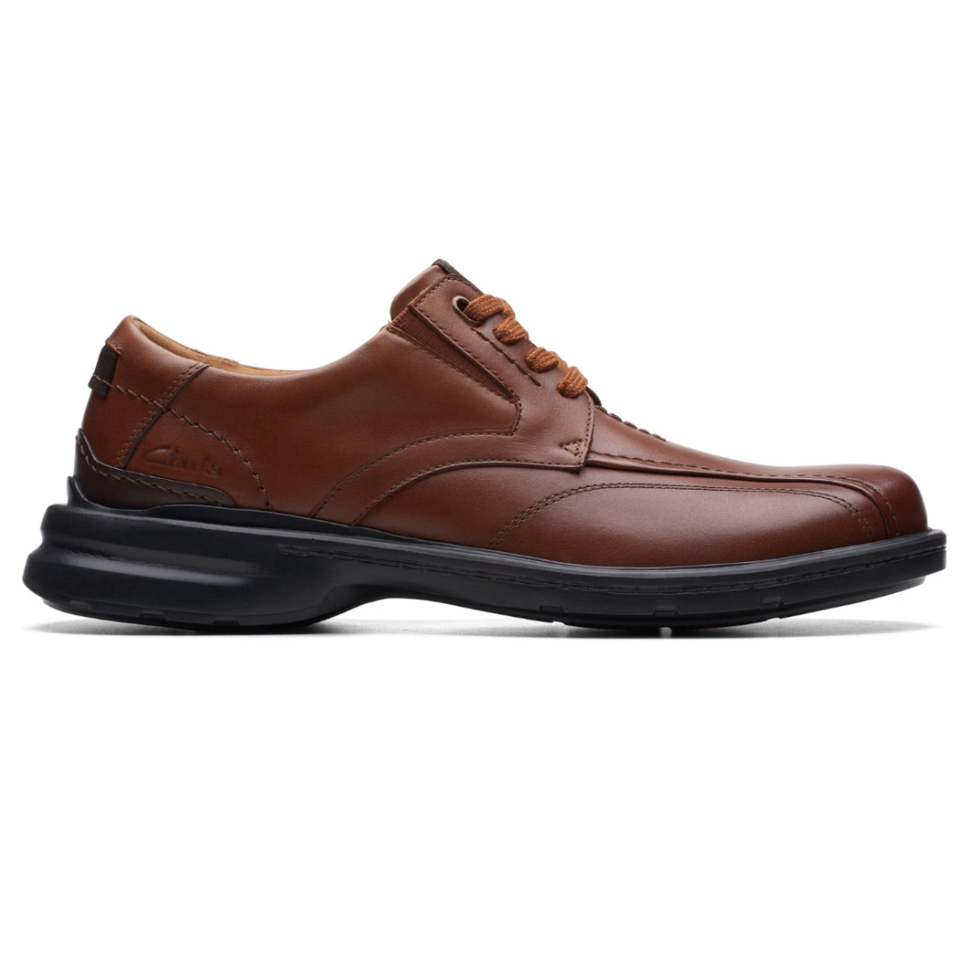 Brown leather lace-up shoe with a black sole, featuring stitched detailing and Clarks branding on the side.