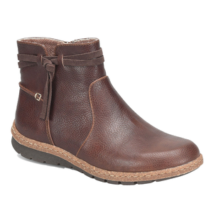 A brown ankle boot with a textured leather finish, featuring a side strap and buckle detail, rubber sole, and decorative stitching around the midsole.